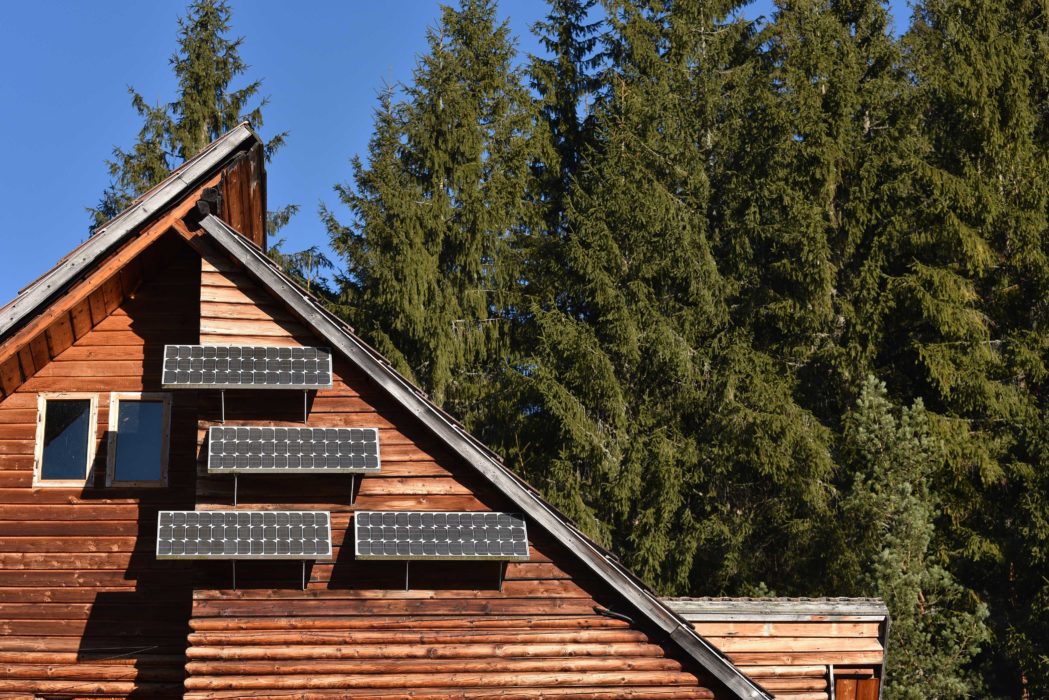 solar-panel-on-a-wooden-cottage-in-the-forest